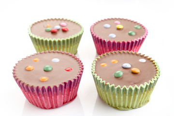 Cupcakes covered with chocolate isolated on white background