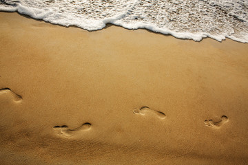path of footsteps on the sand
