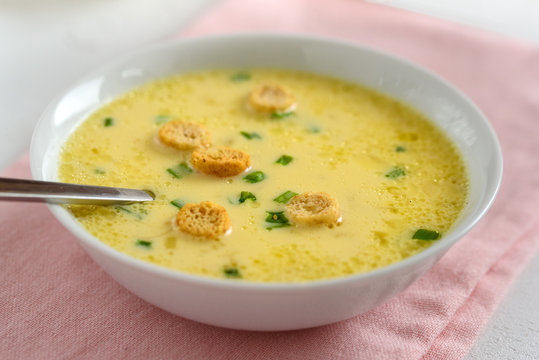Cheese soup with croutons and fresh herbs.