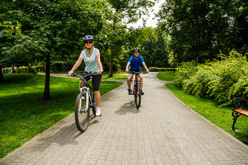 Healthy lifestyle - people riding bicycles in city park