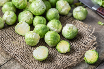 Raw brussels sprouts on jute background.