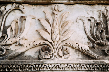 Detail of relief wall with stone carving, old Rome, Europe