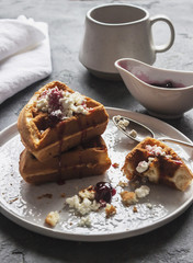 A delicious Breakfast of waffles, cream cheese and jam. Lifestyle. Vertical. Back light. Selective focus
