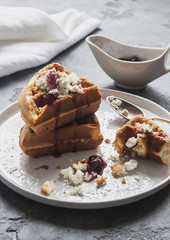 Belgian waffles with cottage cheese and berry jam. Vertical. Back light. Selective focus