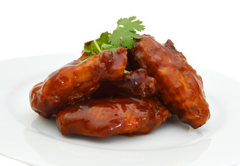 Chicken wings with barbeque sauce in white plate on white