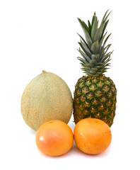 Grapefruits, cantaloupe melon and pineapple on white background