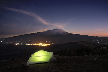 Fototapeta na wymiar Illuminanted Tent, Lights Town And Etna Volcano At Twilight, Sicily