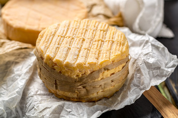 Tasting of oldest french AOC soft pudgent yellow cheese Livarot and Munster, french cheese
