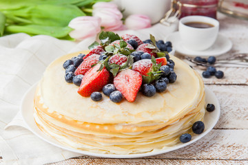 Traditional crepes cake with cottage cheese and strawberry, selective focus