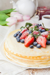 Traditional crepes cake with cottage cheese and strawberry, selective focus