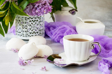 Relaxation time concept. Homemade zephyr with cup of tea on a cozy kitchen table. Copy space, top view flat lay background.