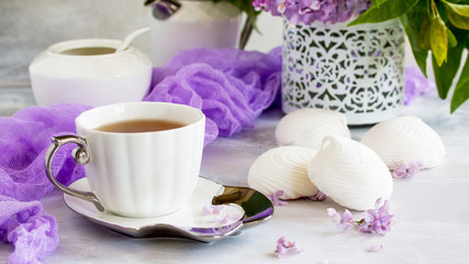 Relaxation time concept. Homemade zephyr with cup of tea on a cozy kitchen table. Copy space, top view flat lay background.