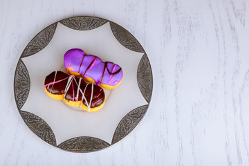 homemade colorful donuts with chocolate and icing glaze on wooden background