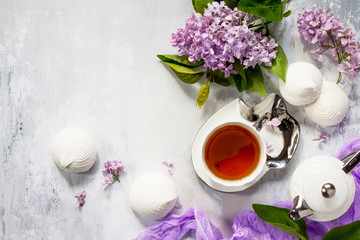 Relaxation time concept. Homemade zephyr with cup of tea on a cozy kitchen table. Copy space, top view flat lay background.