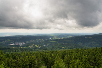 Beautiful summer forest view from Pajndl lookout tower cloudy sky copy space, Tisovsky Mount in Krusne Hory, Bohemia, Czech Republic