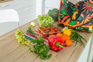 fresh vegetables straight from the market unpacked in the kitchen.