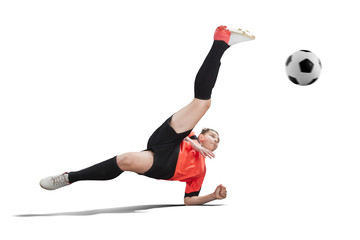 female football player in orange uniform making Bicycle kick isolated