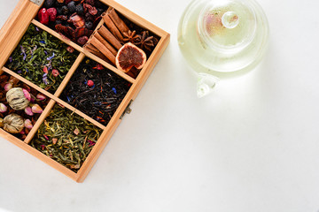 Aromatic dry teas in wooden box. Different tea types : green, black, china, floral.