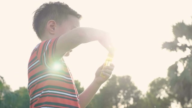 Cute little boy having fun with bubble in slow motion. 
