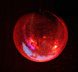 night club lighting red mirror-ball over black