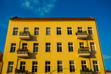 yellow colored apartment building in high contrasts