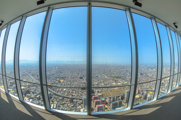 Osaka skyline from observation deck of Osaka's Abeno Harukas, the tallest skyscraper in Japan. Large windows cityscape background.