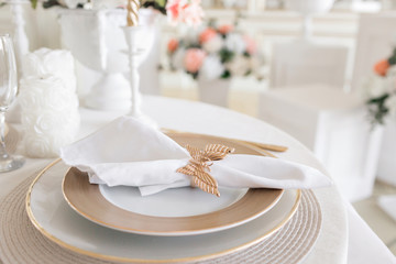 Close-up layout of the festive table. decorated table and chairs for a festive dinner. Luxury decor with daylight. modern photographic studio. Light spring room studio interior.