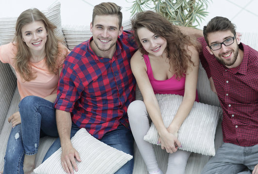 group of friends with pillows, sitting on the couch