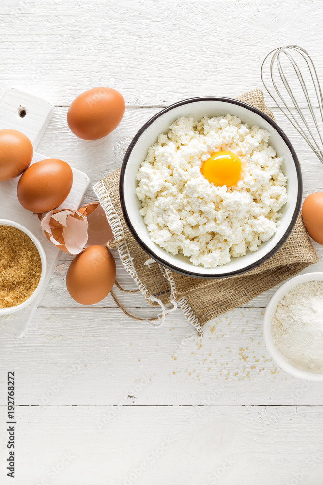 Canvas Prints Culinary background with ingredients for cooking, cottage cheese, baking flour, sugar and eggs on white wooden rustic table, top view