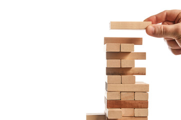 Wood block tower game on white background. Planning, risk and strategy of project management in...