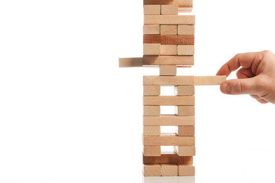 Wood Block Tower Game On White Background. Planning, Risk And Strategy Of Project Management In Business, Businessman And Engineer Gambling Placing Wooden Block On A Tower. Construction Concept.