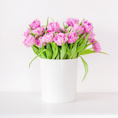 Fresh bright bouquet of pink tulip in white bucket. Beautiful greeting card. Spring holidays concept. Copyspace. Place for your text