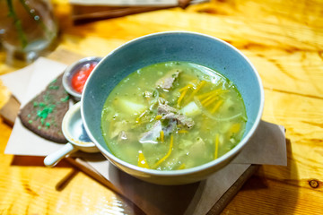 Russian traditional soup schi with rye bread and sauces