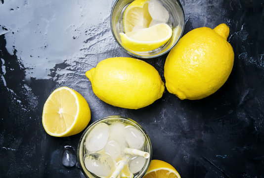 Summer refreshing lemonade with ice and soda, gray background, top view