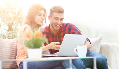 young couple looking at a laptop screen