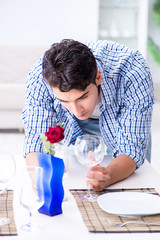 Man alone preparing for romantic date with his sweetheart