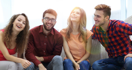 group of cheerful young people sitting on the couch.