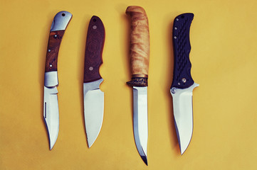 set of hunting knives on yellow background