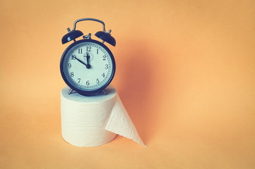 Alarm clock with toilet paper.
