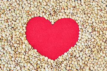 Red heart on a background of dry peas