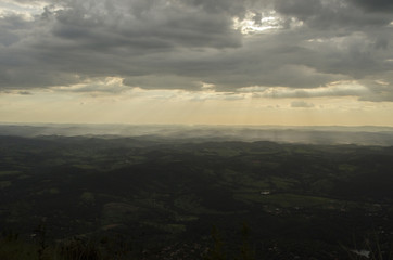 A sunset in clouds by the mountain