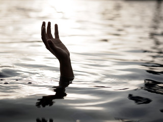 Drowning victims, Hand of drowning man needing help. Failure and rescue concept.