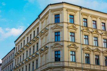 Fototapeta na wymiar residential corner building with yellow facade
