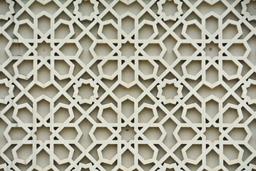 Islamic geometry pattern made from ground fibre reinforcement concrete used as building facade wall decoration. 