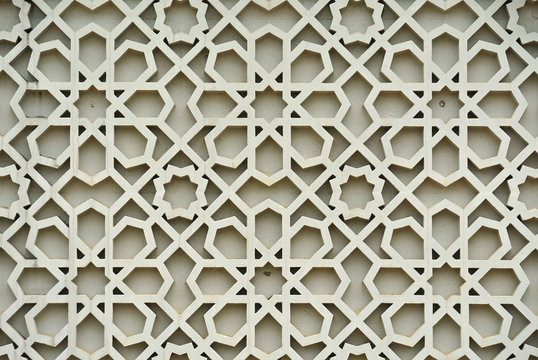 Islamic geometry pattern made from ground fibre reinforcement concrete used as building facade wall decoration. 