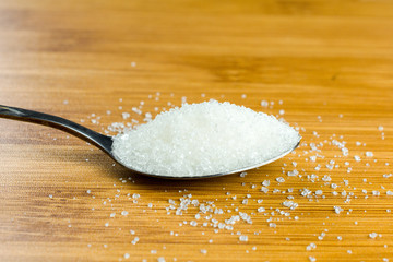 sugar pile spoon wooden table. copy space, close up, selective focus