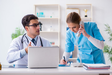 Male and female doctor having discussion in hospital