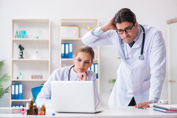 Male and female doctor having discussion in hospital