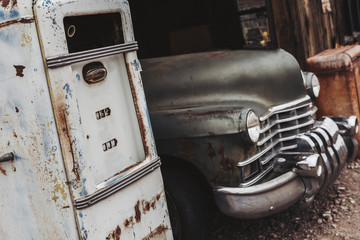 Old vintage rusty car truck abandoned in the abandoned gas station.