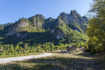Naklejka na ściany i meble View of a valley with rural houses in the mountains of Montenegro 